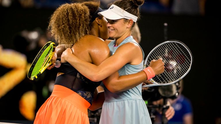Osaka (left) and Brady embrace at the net.